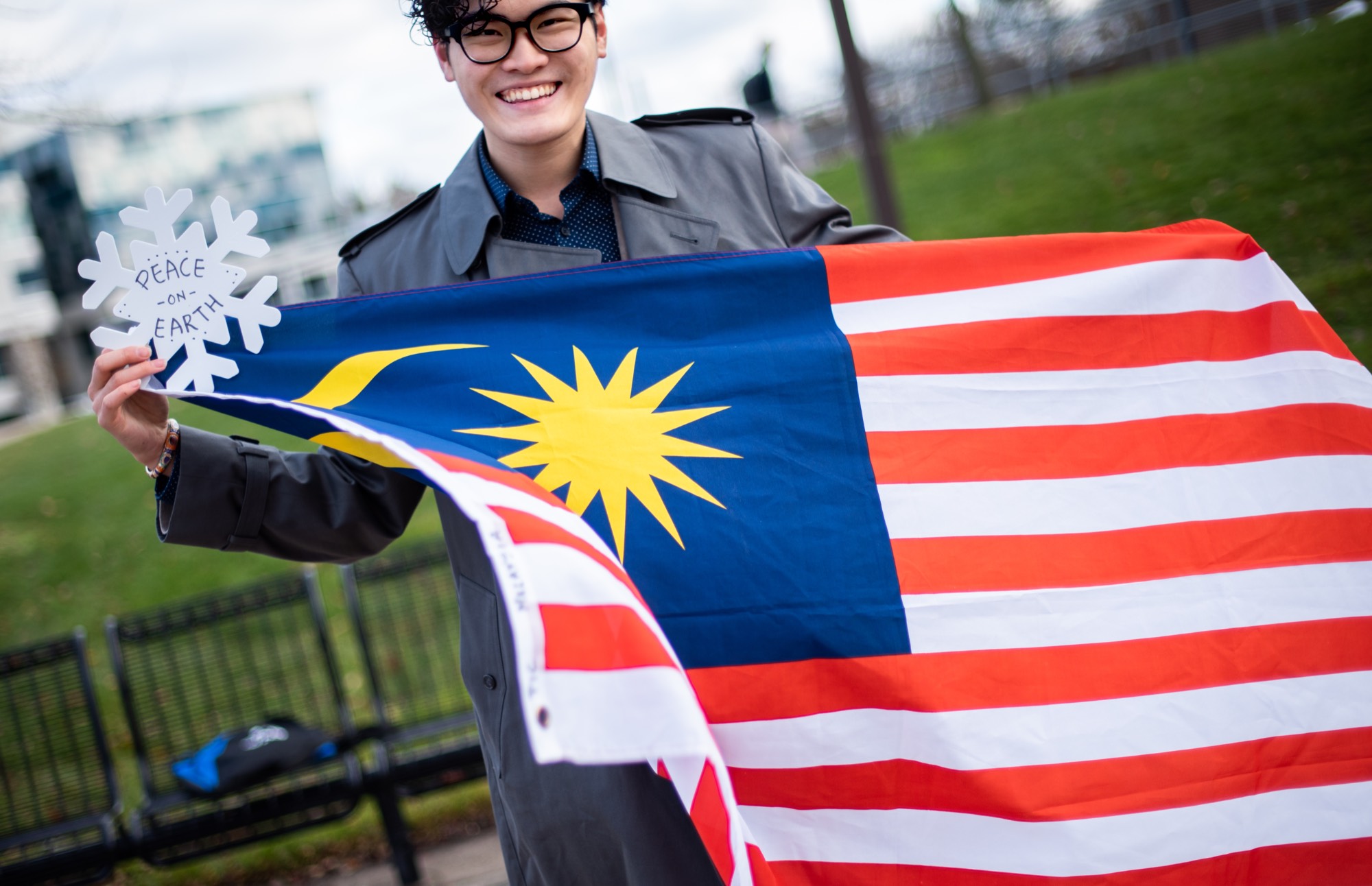 Student holds the Malaysian flag during a holiday celebration